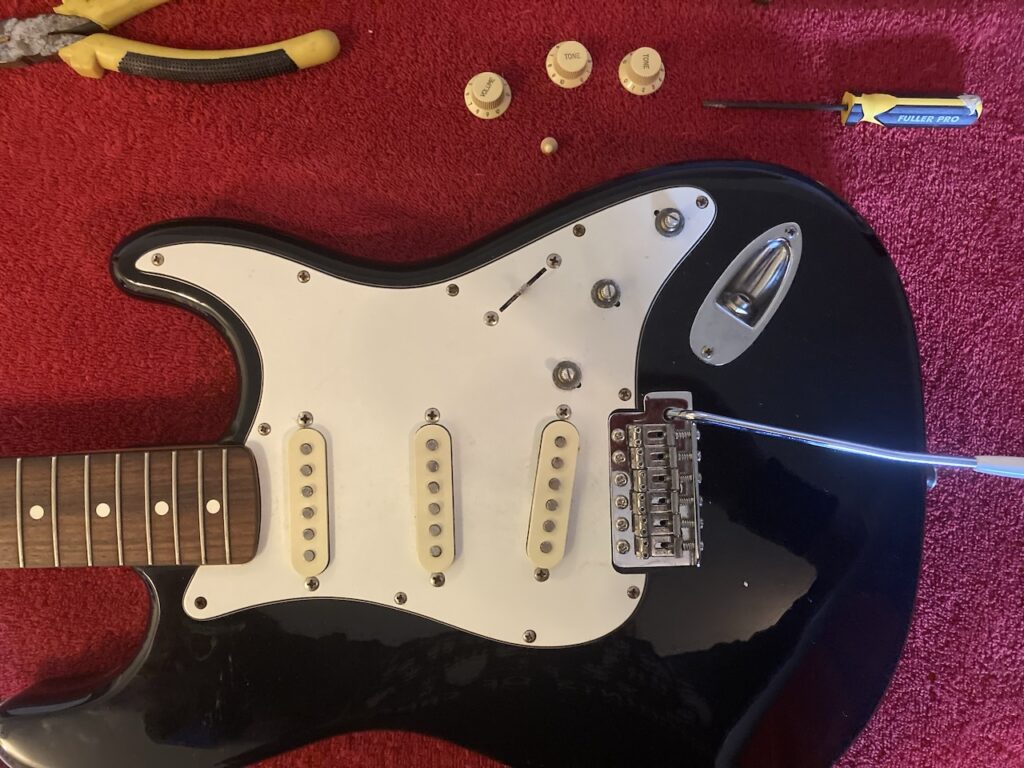 body of Stratocaster with the volume, tone, and switch knobs removed
