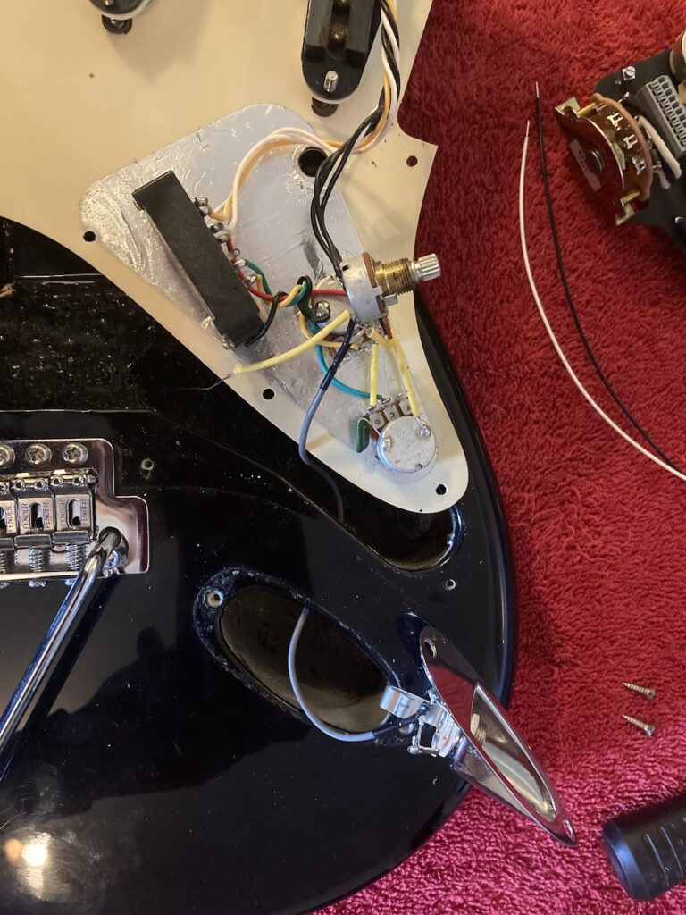 The old output jack being removed from the body of the Stratocaster