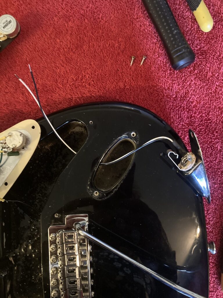 The new output jack being fitted to the Stratocaster body