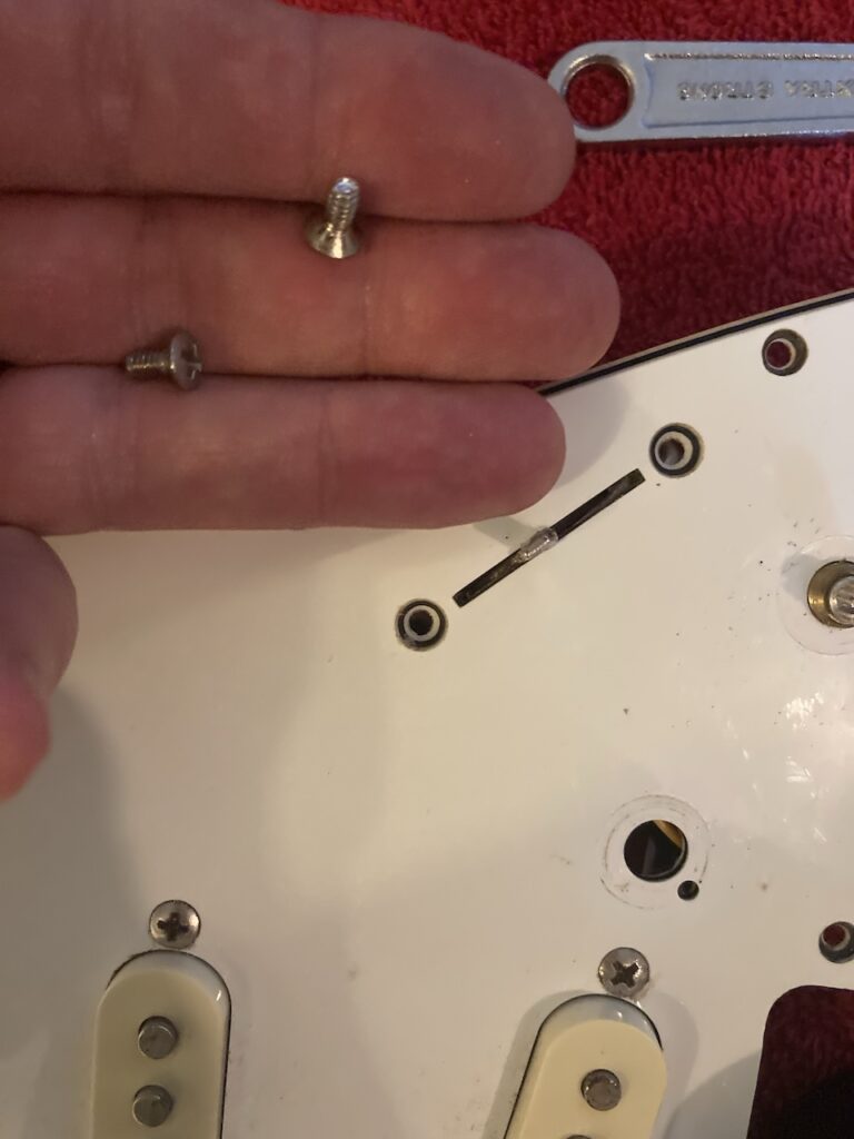 The screws holding the selector switch in place after they’ve been removed