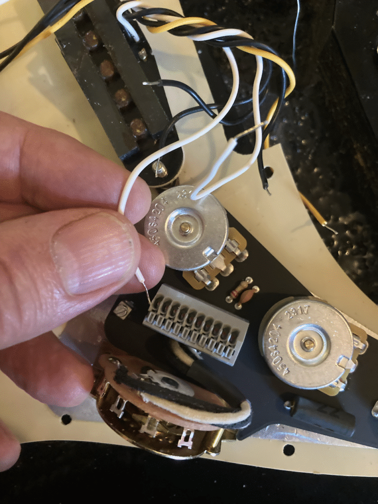 The first wire from a pick-up being connected to the new assembly