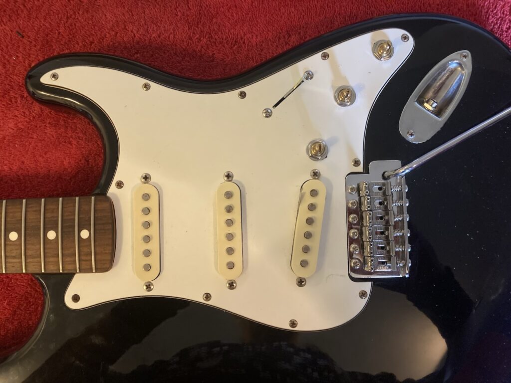 The pick-guard mounted back onto the Stratocaster body
